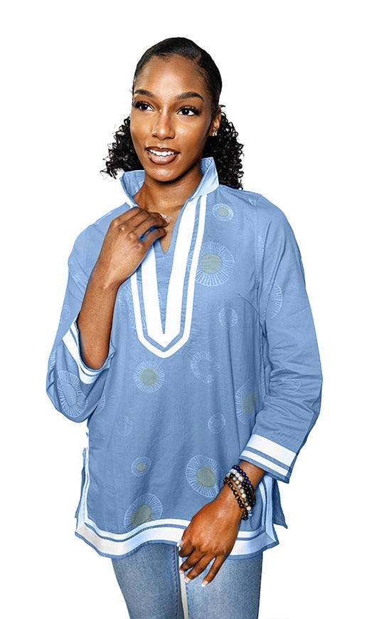 lt blue; tunic with white trim & collar.  Gold circles