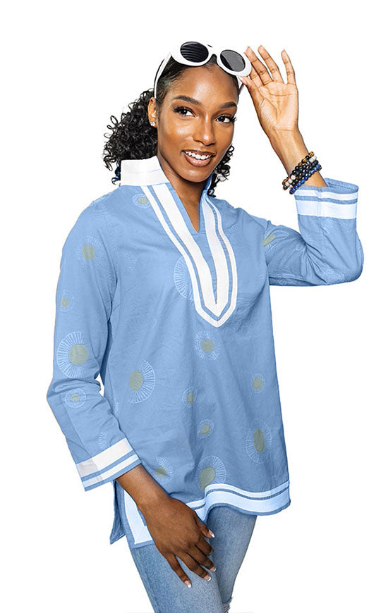 lt blue; tunic with white trim & collar.  Gold circles