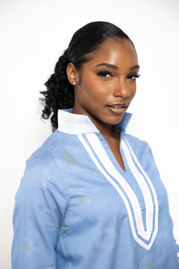 lt blue; tunic with white trim & collar.  Gold circles